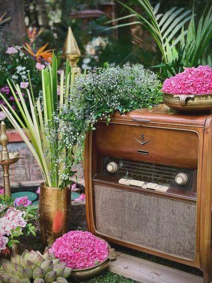 We love incorporating unique, personal touches like this vintage radio, adorned with fresh flowers. Antique props can add a wonderful sense of nostalgia and character to a wedding's decor, telling a story that is unique to the couple.