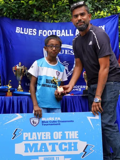 A player from our U11 team receives the "Player of the Match" award. Recognizing outstanding performance in a single game is a great way to boost morale.