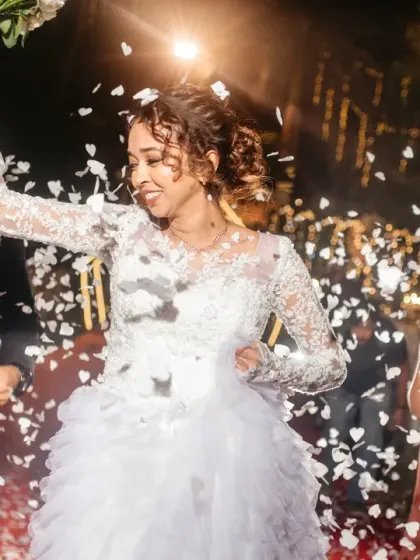 The grand reception entrance, with guests showering the happy couple in confetti. The energy and excitement of this moment is contagious.