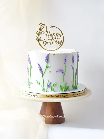 A closer look at the delicate buttercream lavender stalks on this elegant birthday cake.