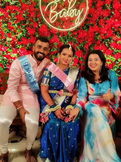 A happy photo with the parents-to-be, Pranita and Gaurav. Their sashes say 'Dad to be' and 'Mom to be', adding a fun touch to their outfits.