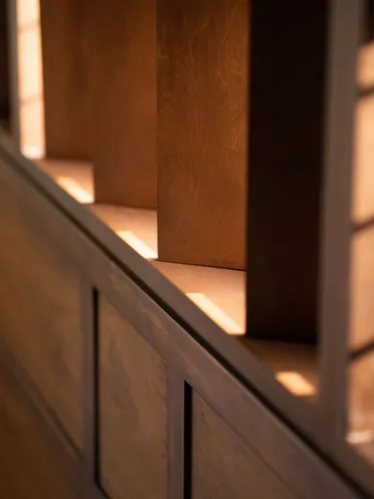 The intricate patterns of light and shadow created by the wooden screens add depth and character to the space.