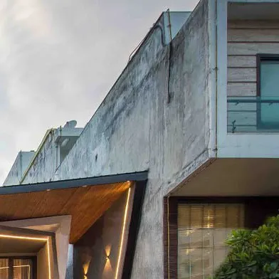 A detail showing the junction between the new architectural form and the neighboring building, highlighting the project's contextual sensitivity.