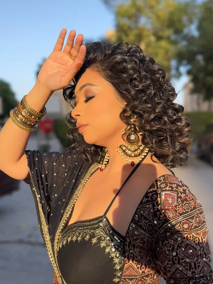 Golden hour in my festive lehenga. The warm sunlight brings out the rich colors and intricate details of the Ajrakh print and the heavy earrings.