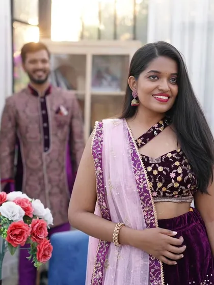 A beautiful candid-style shot focusing on the bride-to-be. The intricate details of the velvet lehenga top are clearly visible here.