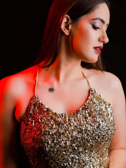 A close-up beauty shot showing a classic red lip and winged eyeliner, the perfect makeup to pair with this showstopping gold dress.