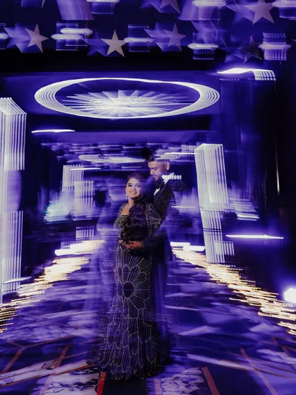 Another take on using motion blur to create a dynamic and artistic Sangeet portrait. The streaking lights give a sense of dizzying celebration, with the couple as the calm, happy center of it all.