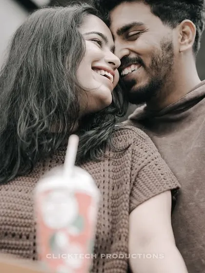 An intimate and joyful close-up of a couple, their smiles and connection being the main focus of this candid shot.