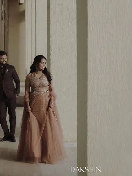 A beautifully composed engagement photo using architectural lines and soft light to create a cinematic feel.