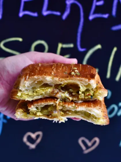 The cross-section of our Kasundi Chicken Pain Suisse. This savoury croissant pastry is filled with a tangy Bengali Kasundi mustard chicken, offering a unique and delicious flavour combination.