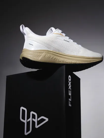 A hero shot of a white sneaker placed on its branded box. The dramatic, single-source lighting creates a premium, high-impact image that makes the product look powerful and desirable.