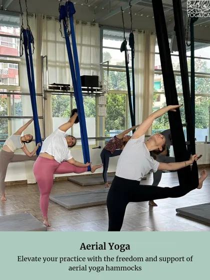 An image from a retreat brochure, showcasing an aerial yoga class. We elevate our practice with the freedom and support of aerial yoga hammocks.