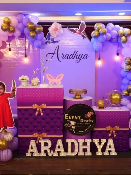 A Sofia the First theme for a royal first birthday celebration. The purple and gold color scheme, castle-like backdrop, and character cutouts make for a truly princely party.