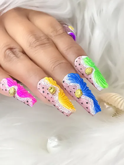 A full hand view of the multi-colored shell effect nails, showing how each nail has a different bright color for a playful and eye-catching set.