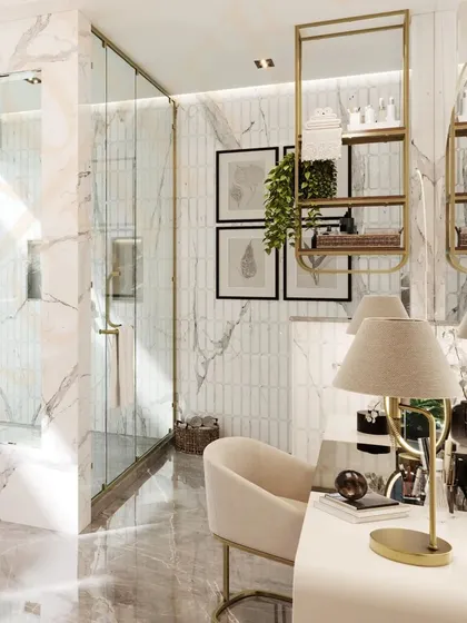 A close-up of the dressing table area, complete with a comfortable chair, a lighted mirror, and elegant gold-accented shelving.