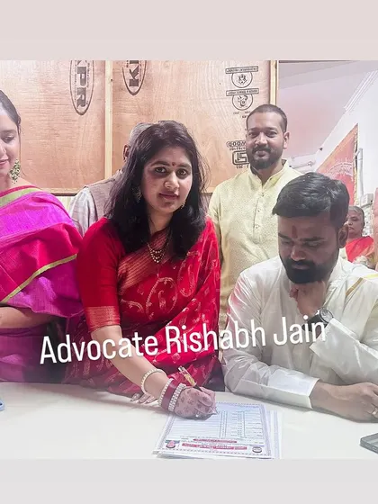Here, a bride signs the legal documents for her marriage, surrounded by family. I help ensure that even love marriages become successful, legally recognized unions with full family support.
