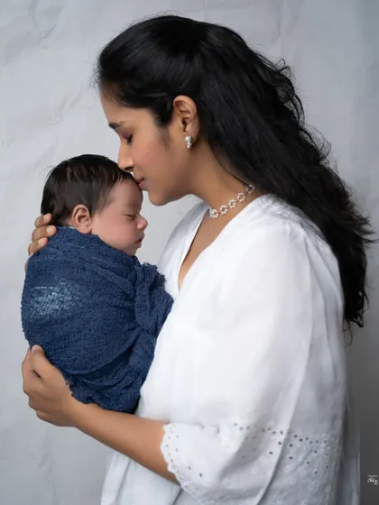 A mother's gentle kiss on her baby's forehead is a classic and timeless expression of love that I always aim to capture.