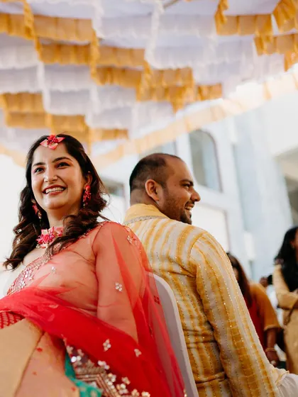 A sweet, candid moment between the couple during their Haldi ceremony games. Their smiles show the love and fun that fill the air.