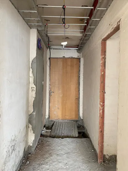 Before: The raw entryway of a villa in Noida, a narrow passage awaiting a complete makeover.