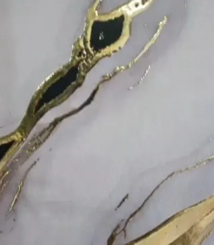 A close-up detail of a gold foil wallpaper. The metallic elements catch the light beautifully, adding a touch of glamour and sophistication that cannot be achieved with standard paint or prints.