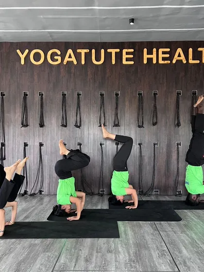 The progression of a tripod headstand. This image captures four of our students at different stages of entering the pose, showcasing the journey of learning an inversion.