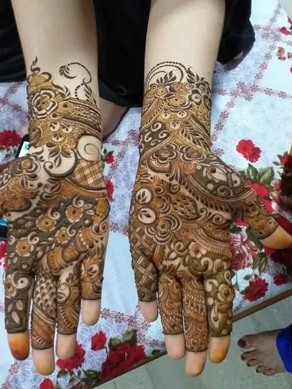 Full coverage party mehndi for a festive look, with rich details on both hands.