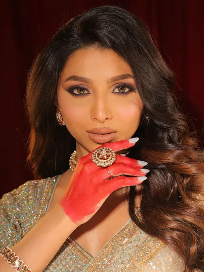 A close-up of the enchanted look. The red-stained hands add a traditional and artistic touch to the overall aesthetic.