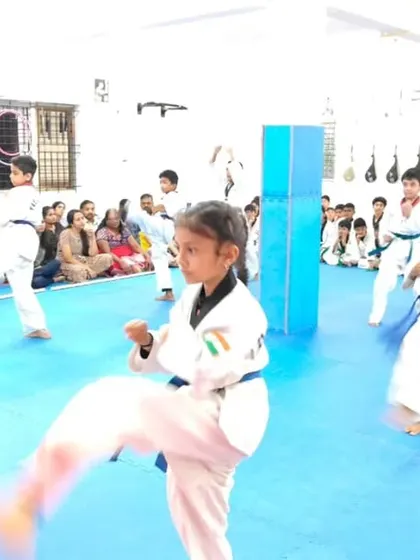 A student practices a front kick.