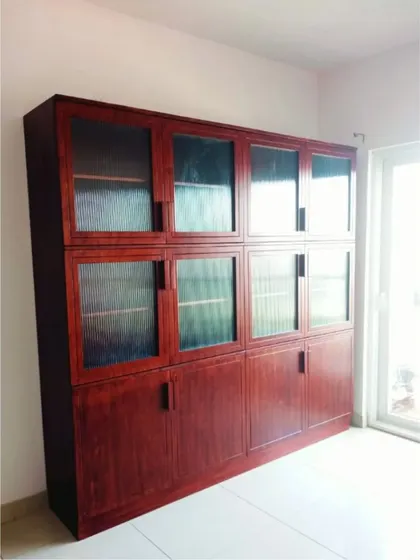 A side view of the large bookshelf, showing its impressive scale and the quality of the wood finish.