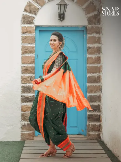 A joyful portrait of the bride in her traditional Nauvari saree, showcasing the vibrant colors and intricate details of her attire.