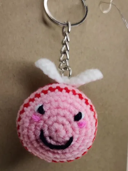A cute pink and red striped bee.