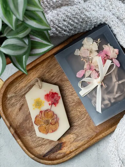 A close-up of one of my floral wax tablets. I carefully press real dried flowers into the wax, creating a unique design every time. This one is ready to be gifted in its own special box.