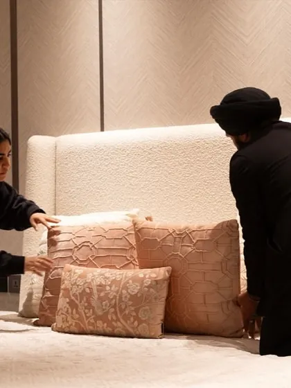 A behind-the-scenes moment of our team giving the final touches to the bedroom styling. This hands-on approach ensures that every detail is perfect before we hand over the space.