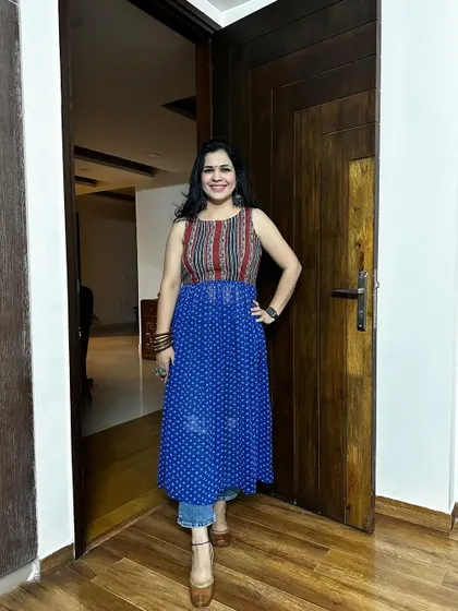 A fusion-style kurti created from two different fabrics. The yoke is made from a striped fabric, while the bottom flare is a blue bandhani print, creating a unique and eye-catching piece.