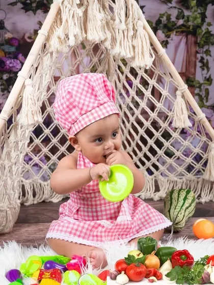 Our little chef surrounded by fresh vegetables and cooking tools. I provide a wide range of props to make every themed shoot feel authentic and fun.