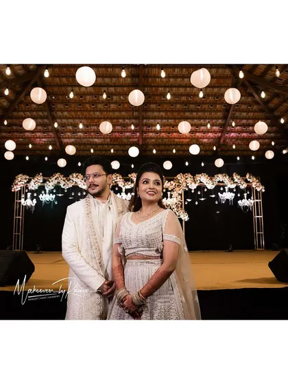 A wide shot of the couple on their beautifully decorated Sangeet stage.