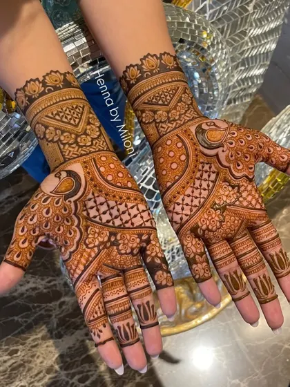 A rich and detailed design with peacock motifs and intricate patterns. The use of dots and checks adds a lot of texture.