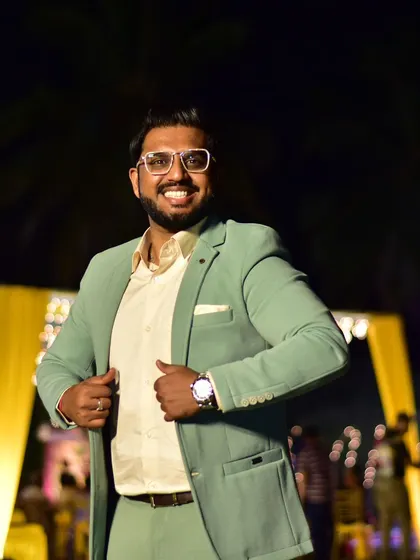 A big smile is the best accessory. A candid shot of me in a mint green suit at an outdoor reception.