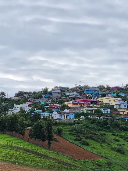 A colorful village nestled in the hills. These landscapes look like they're straight out of a childhood scenery painting.
