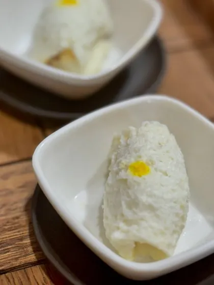 A close-up of the Chena Roll, a Bengali delicacy made from fresh cheese (chena) and stuffed with fragrant mawa, then soaked in a light syrup.