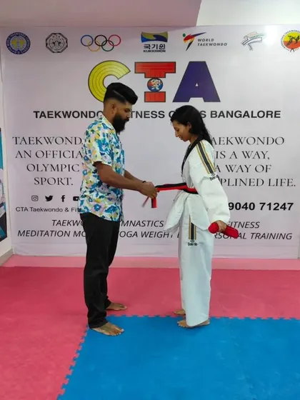 Tying a red belt.