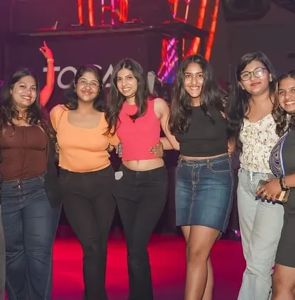 A group of friends posing for a photo, capturing a fun moment from their night out.