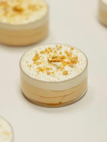 A layered dessert in a cup, finished with crunchy flakes and a touch of gold leaf. These are perfect for learning about composition and plating.