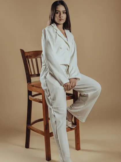 A full-length shot from the 'Allure' editorial series. The makeup is designed to complement the monochromatic styling, proving that sometimes less is more.