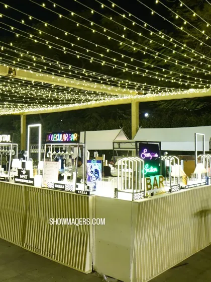 A modern, multi-station bar setup under a canopy of fairy lights for a Sufi themed reception. We included neon signs to label different bars like 'Molecular Bar' and 'Cocktail'.