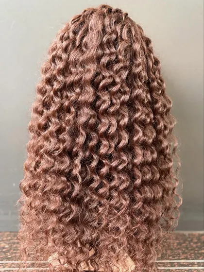 Another angle of the rich, dark brown curly wig, showing its texture and volume.