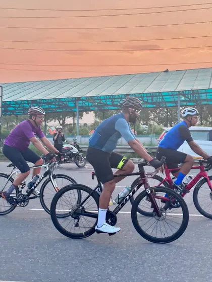 A great action shot of the group riding against a sunset-hued sky.