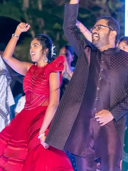 The bride and groom lead their friends and family in a high-energy dance number. This is what a sangeet is all about: shared joy, laughter, and making memories together on the dance floor.