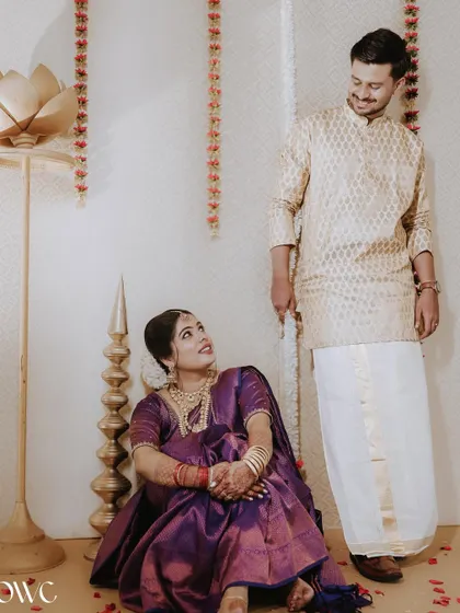 A playful interaction between a couple during their indoor pre-wedding shoot, filled with smiles and affection.