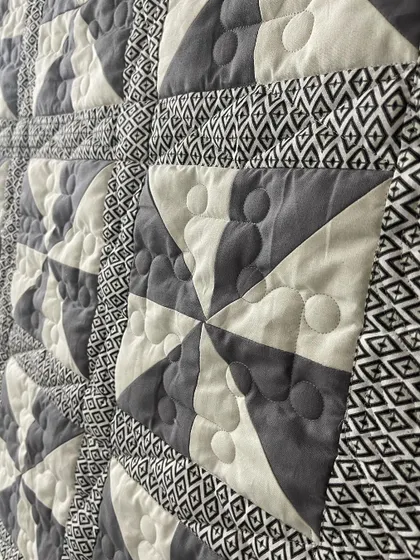 A close-up of the pinwheel blocks, showing the bubble quilting pattern.